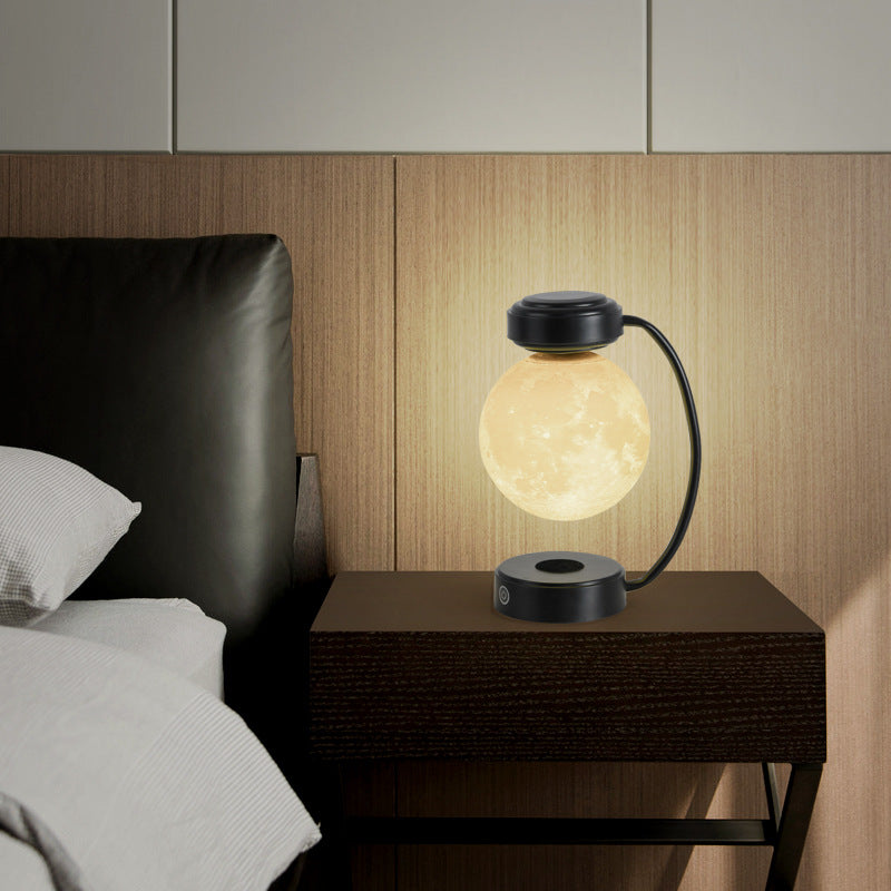 Moon Night Light 3D LED Magnetic Levitating Floating Lamp illuminating a dark space with a glowing moon design. Moon Night Light 3D LED Magnetic Levitating Floating Lamp illuminating a dark space with a glowing moon design.
