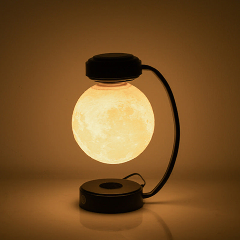 Moon Night Light 3D LED Magnetic Levitating Floating Lamp illuminating a dark space with a glowing moon design. Moon Night Light 3D LED Magnetic Levitating Floating Lamp illuminating a dark space with a glowing moon design.