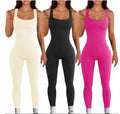 9d7286c4f2b7e7e55dfeaf347afd6404Women's Suspender Tank Top Tights in black worn by a model at the beach, showcasing a stylish and comfortable fit.